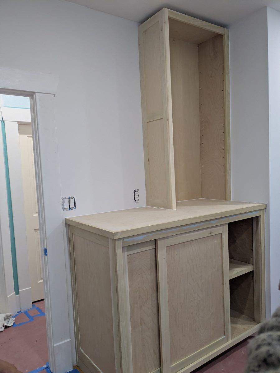 Unfinished custom built-in cabinet installed during the nursery conversion
