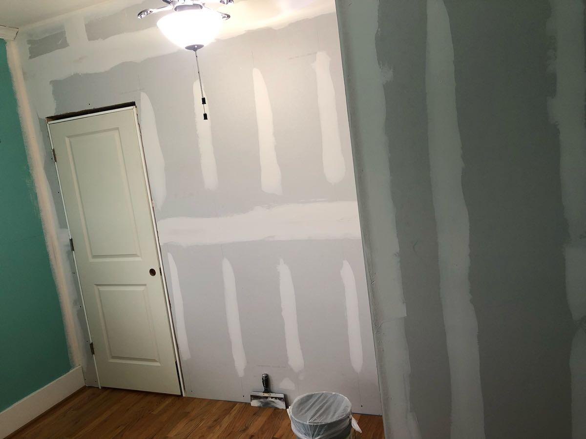 New drywall and doorway during the Heights room-conversion process