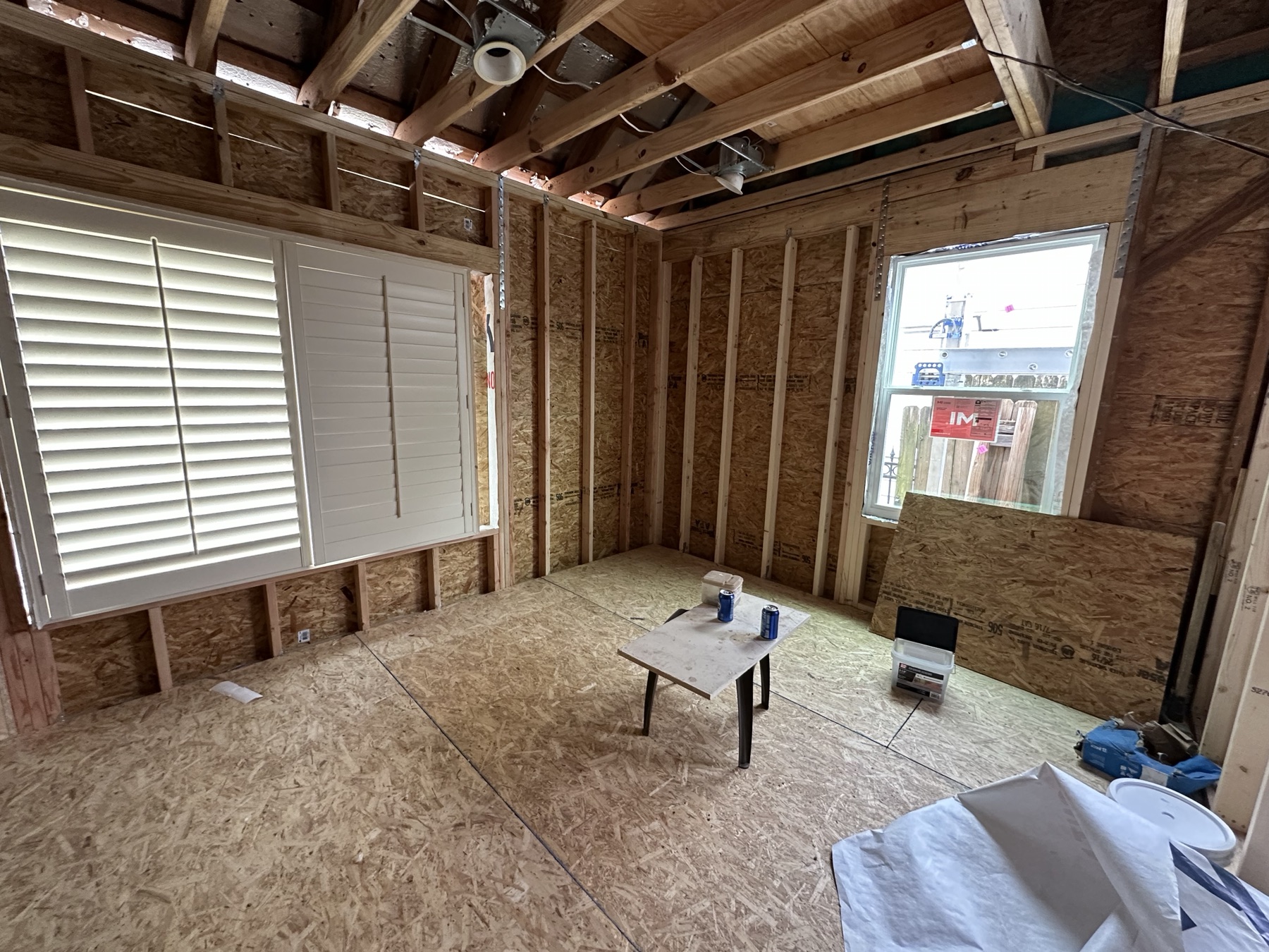 Rebuilt room shell with new subfloor, wall framing, and ceiling framing